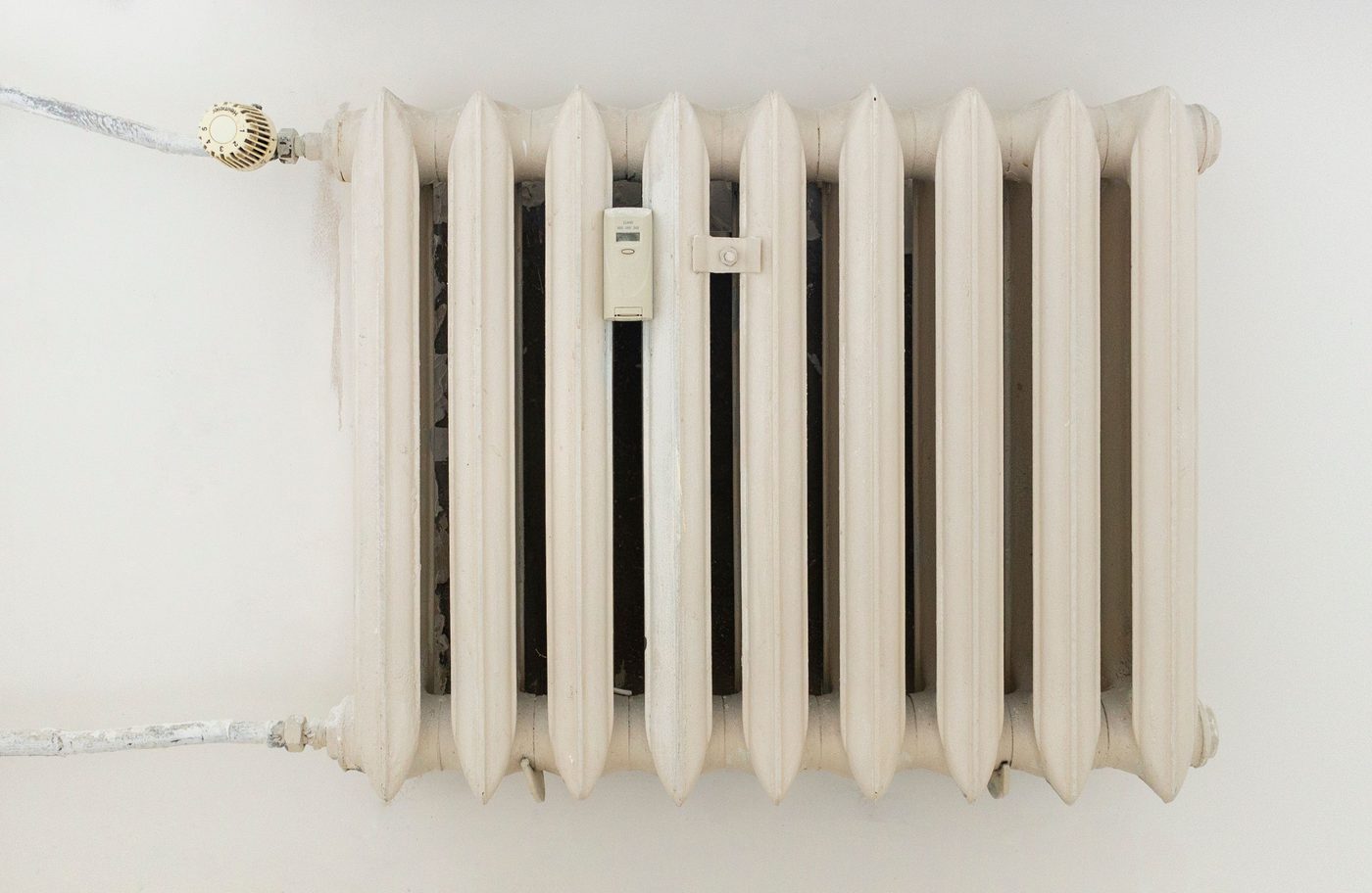 Classic white column radiator on a plain wall